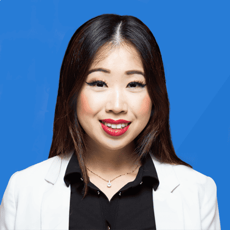 Felicia Lin, gekleed in een witte blazer en rode lippenstift.